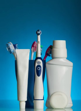 Electric toothbrush, manual toothbrushes in holder