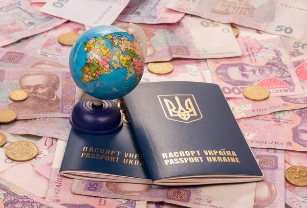 Globe and passport, located on the background of the set of money for the journey — Stock Photo, Image