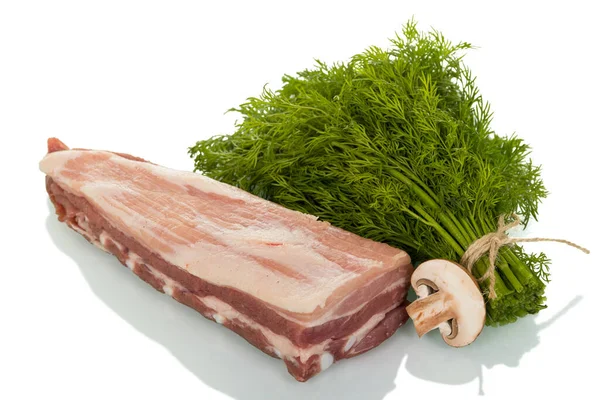 Piece of pork ribs, next to a bunch of dill and mushroom isolated on white — ストック写真