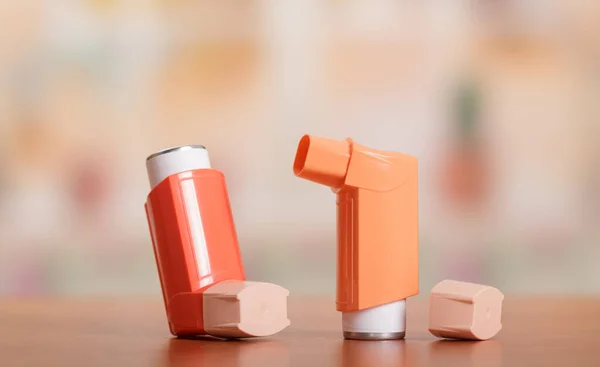 Two small pocket inhaler to relieve an asthma attack, on table — ストック写真