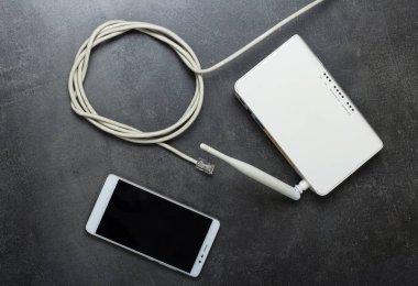 Bağlantı rj45 'li internet kablosu, kablosuz ağ ve akıllı telefonu gri üzerinde kullanmak için yönlendirici