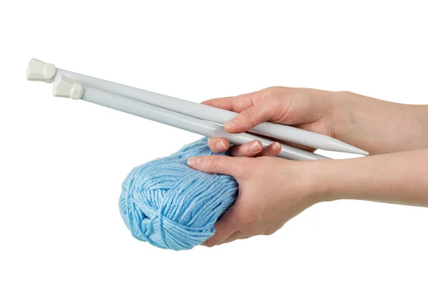 Skein of blue yarn and thick spokes in woman 's hands isolated on white — стоковое фото