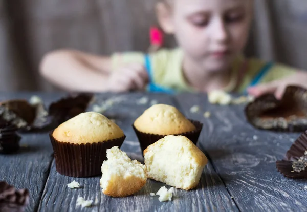 Freshly baked delicious cupcake broken on grey surface — Stock Photo, Image