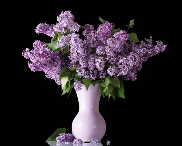 Beautiful bouquet of lilac in vase isolated on black — Stock Photo, Image