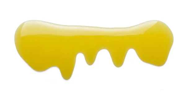 Kleine plas vloeibare goudkleurige honing is geïsoleerd op wit — Stockfoto