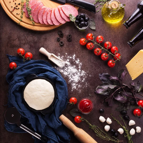 Готовое тесто и набор продуктов для приготовления пиццы на рабочей поверхности — стоковое фото