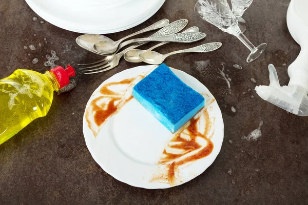 Dirty dishes, detergent and sponge isolated on black — Stock Photo, Image