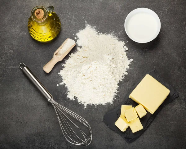 Two types of oil, sour cream and flour for kneading dough, on work surface — Stock Photo, Image