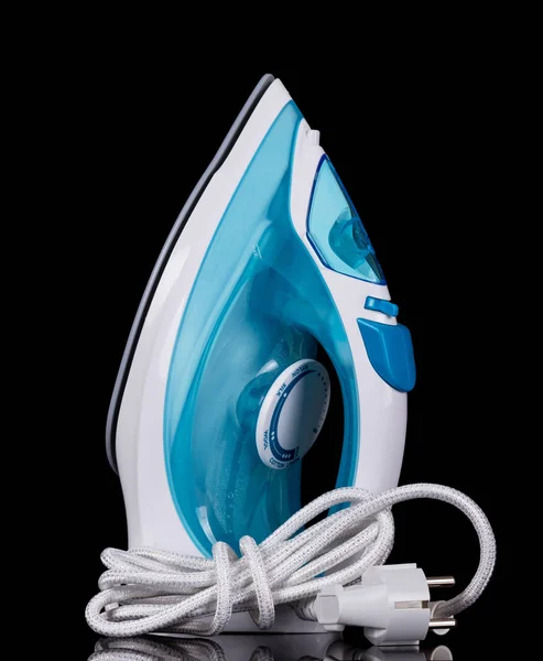Electric iron with humidifier stands isolated on black — ストック写真