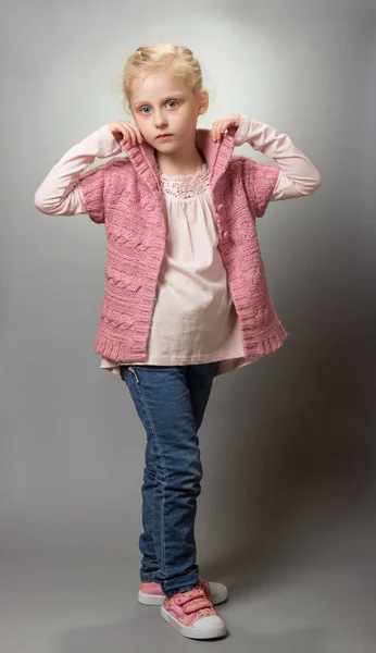 Charming little fashionista in jeans on gray — ストック写真