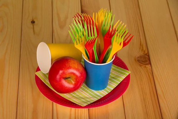 Many Disposable Forks Plastic Cup Apple Plate Beige Wooden Table — Stock Photo, Image