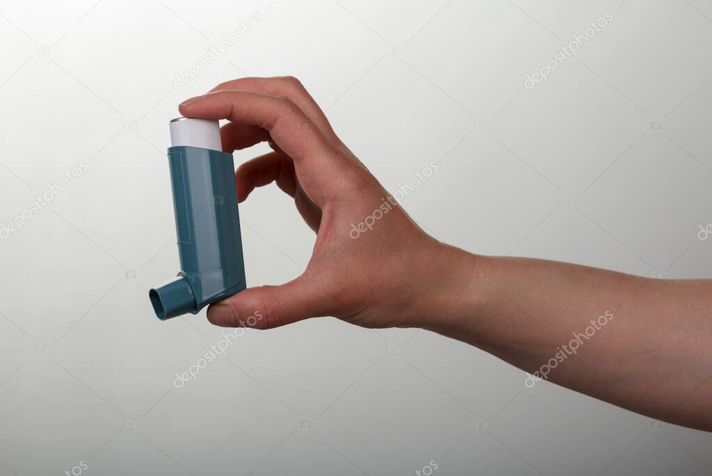 Pocket inhaler is ready for work, on gray background