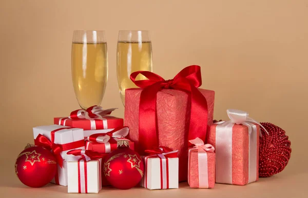 Veel Kerstcadeaus Verschillende Mooie Dozen Glazen Champagne Beige Achtergrond — Stockfoto