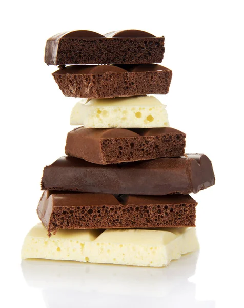 Stack of porous pieces of milk and black chocolate isolated on a white background.