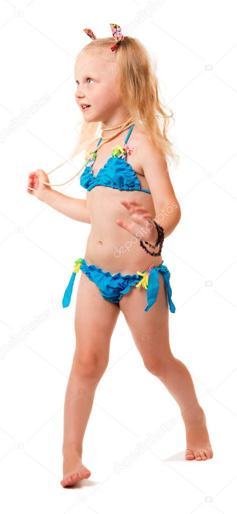 Little blond girl in a swimsuit with bijouterie isolated on white background.