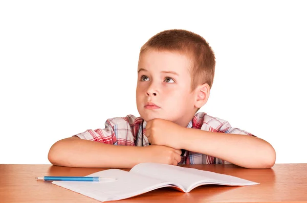 Niño Soñador Sentado Una Mesa Sobre Cuaderno Aislado Sobre Fondo —  Fotos de Stock