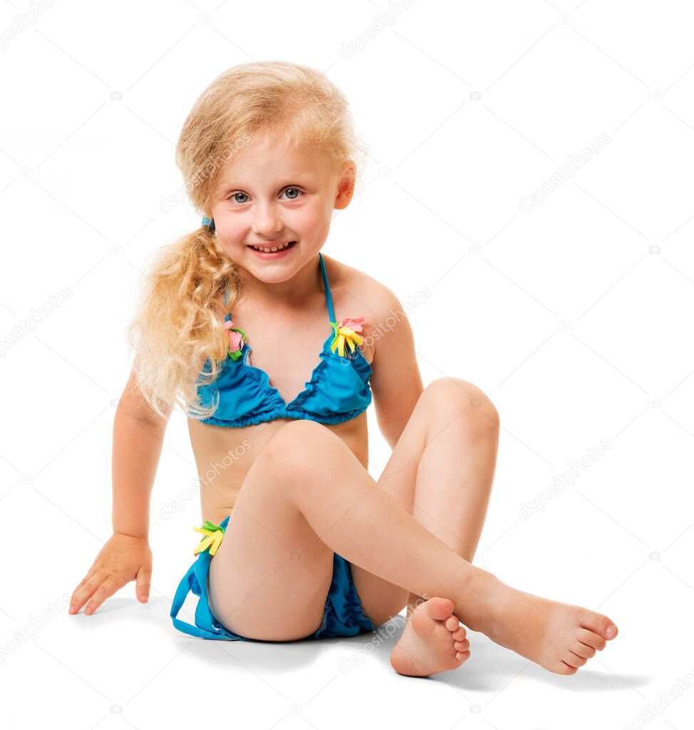 Seated little blond girl in a swimsuit isolated on white background.