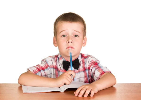 Niño Triste Con Pluma Mano Está Sentado Una Mesa Cuaderno —  Fotos de Stock