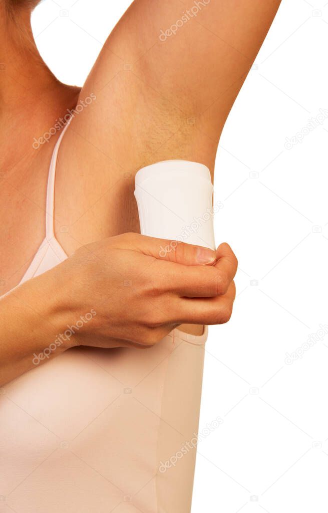 An unknown woman uses a dry underarm deodorant isolated on white background.