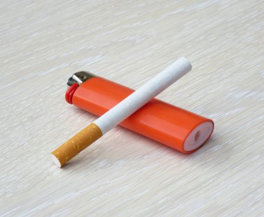 Çakmak ve sigara bir ahşap yüzeye döşeme.
