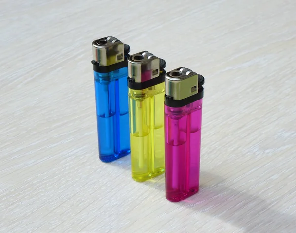 Tres encendedores de varios colores —  Fotos de Stock