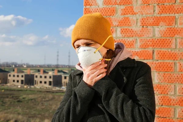 Woman wearing face mask at the street. The concept of the epidemic of the virus. Protect yourself.