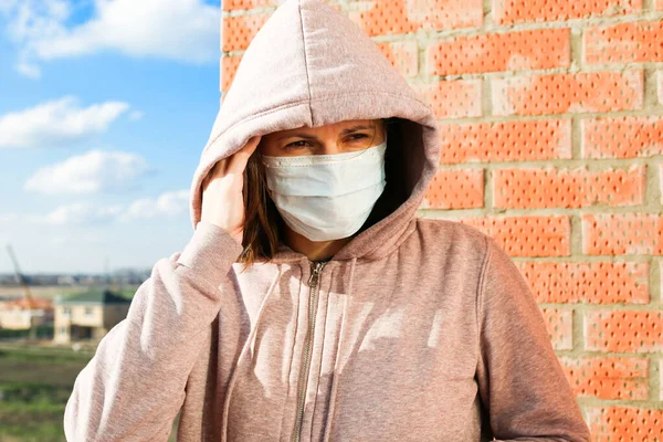 Corona Virus concept. Woman wearing face mask at the street. The concept of the epidemic of the virus. Protect yourself.