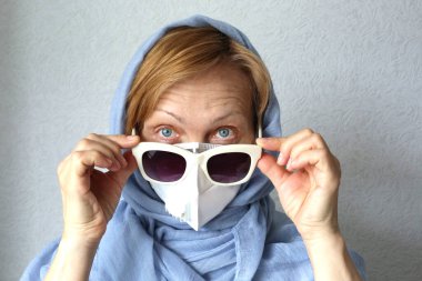 Virüse karşı filtre maske takan olgun bir kadın. Moda tıbbi yüz maskesi.