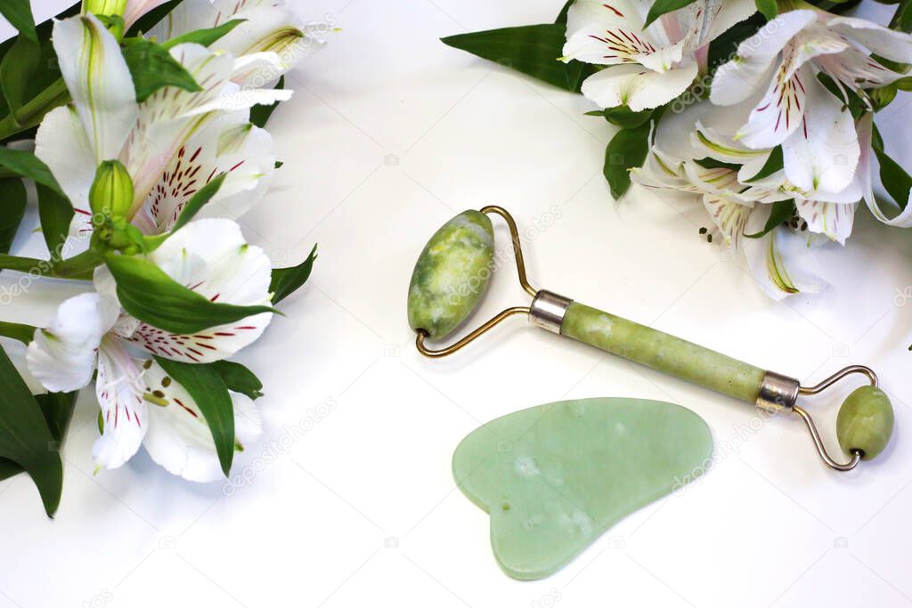 Face roller facial skin care luxury beauty tool.  Close up view of green face roller. Beauty tools.