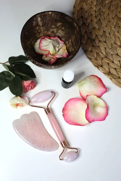 Natural organic cosmetics face roller and gusha for skin treatment. Pink quartz face roller.