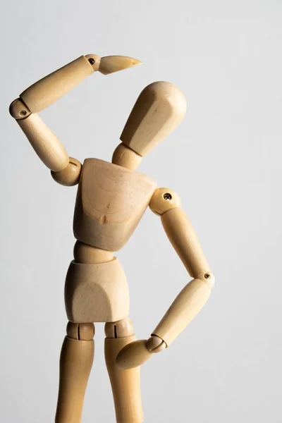 Vertical Closeup Shot Wooden Pose Doll One Hand Its Head — Stock Photo, Image