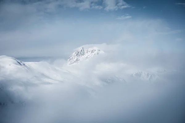 Breathtaking Scenery Alps Covered Snow Enveloped Fog Cloudy Sky Great — Stock Photo, Image