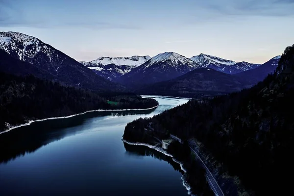Schöne Aufnahme eines breiten Flusses zwischen den Hügeln mit dem Himmel im Hintergrund — Stockfoto