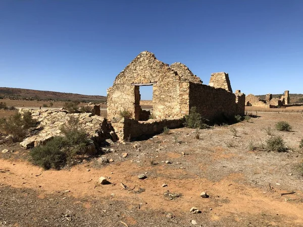 A beautiful shot of ruins in the desert with a blue clear sky in the background at daytime