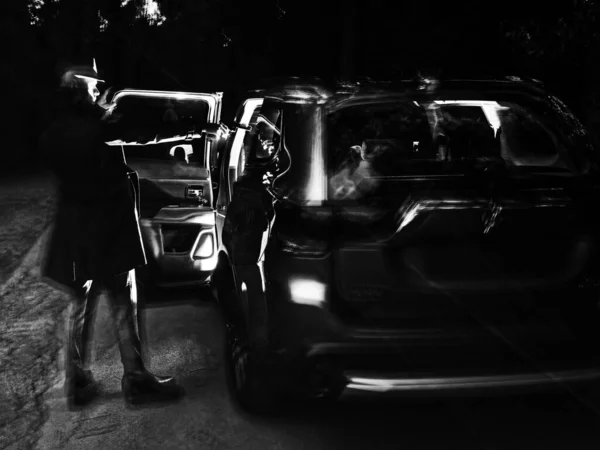 Abstract grijsbeeld van een menselijk silhouet dat de deur van een auto opent — Stockfoto