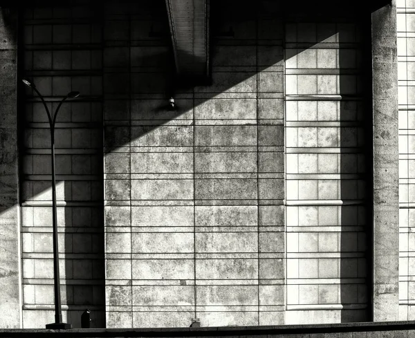 Tiro simétrico a escala de grises de un muro sombreado de piedra - depresión, concepto de soledad —  Fotos de Stock