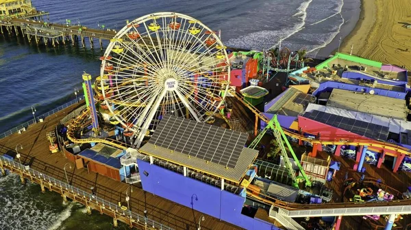 Aerial shot of a park with different kinds of rides at the beach — Stock Photo, Image