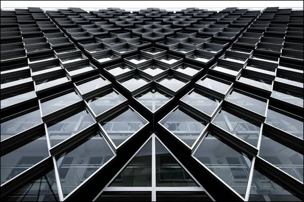 Low angle shot of a modern building with abstractly shaped windows — ストック写真