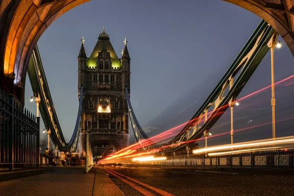 Timelapse shot of car lights on the historic London bridge at night time — 스톡 사진