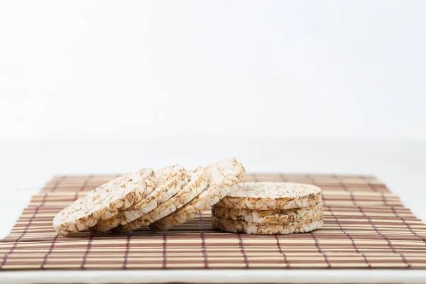 A stack of delicious pignolia cookies on a striped cloth isolated on a white background — Stock Photo, Image