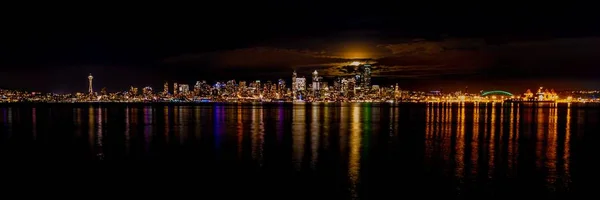 Panoráma felvétel a tükröződés a fények és épületek Seattle, USA a vízben éjszaka — Stock Fotó