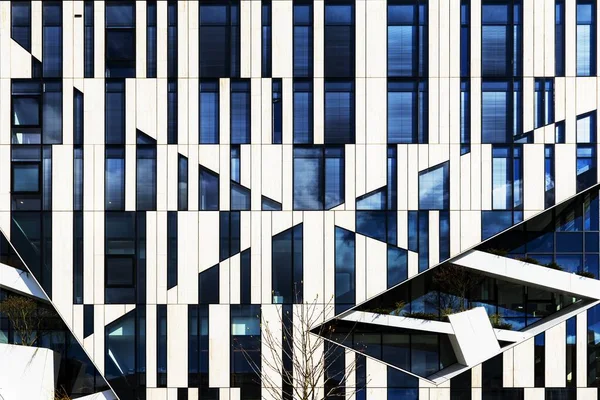 Beau cliché d'un bâtiment moderne blanc et bleu avec des fenêtres en verre — Photo