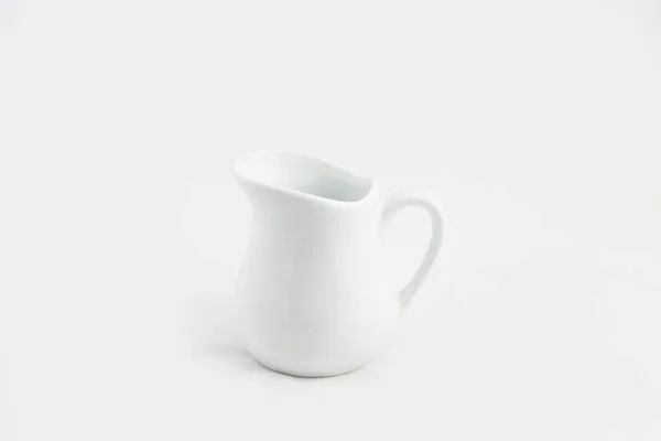 Closeup shot of a white ceramic pitcher isolated on a white background — Stock Photo, Image