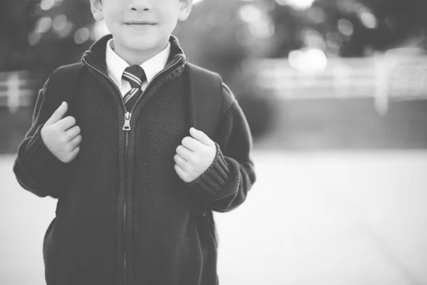 Grayscale Shot Child Wearing School Uniform Backpack Blurred Background — Stock Photo, Image
