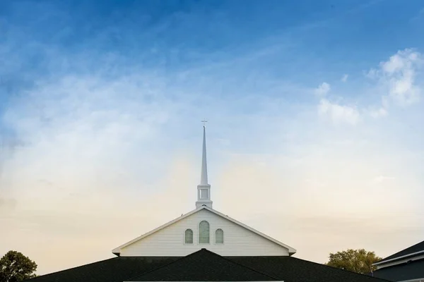 Beautiful shot of the church with a blue cloudy sky in the background — Stock Photo, Image