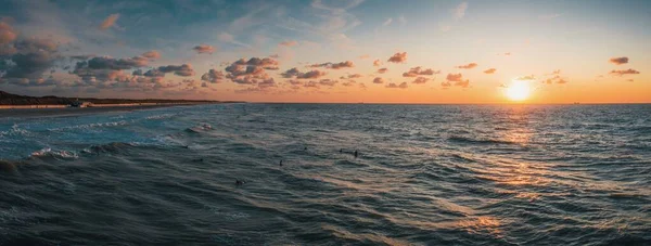 Panoramic shot of the beautiful sunset over the ocean captured in Domburg, Netherlands — Stock Photo, Image