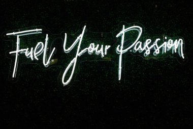Text fuel your passion on neon signage - perfect for a motivational background clipart