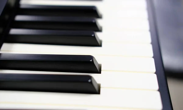 Closeup shot of the keys of a piano - creating the art concept — Stock Photo, Image