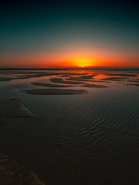 Vertical shot of the reflection of the sunset in the ocean captured in Domburg, Netherlands — Stock Photo, Image