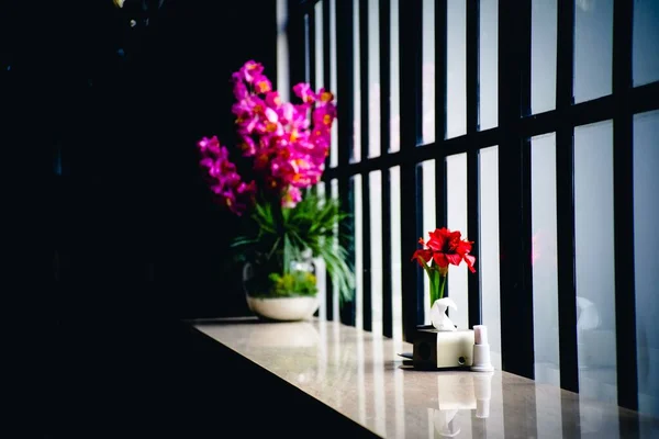 Beautiful flower vases by a window